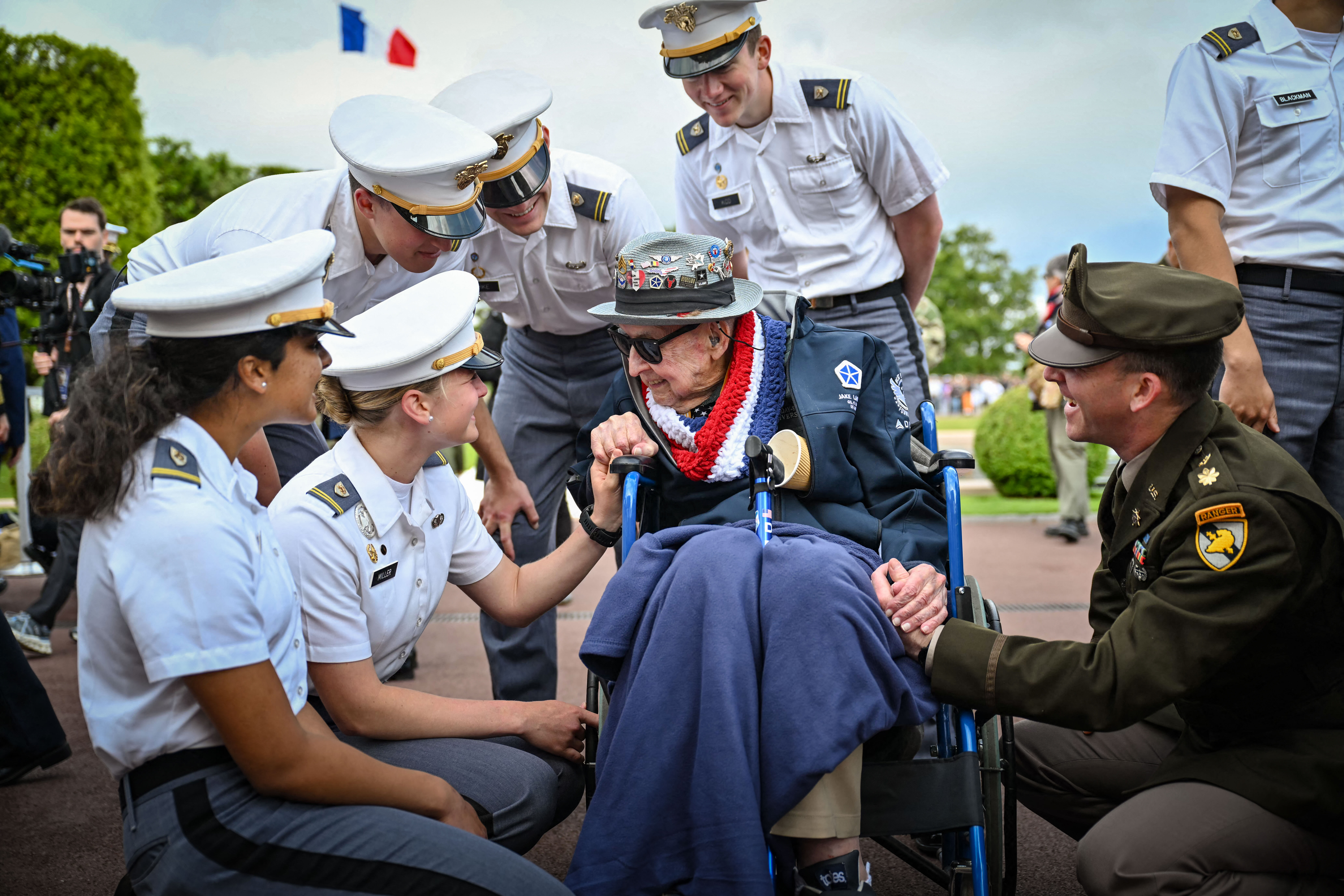 Day in Photos: D-Day Landing Anniversary, ICE Detention, and Train Strike