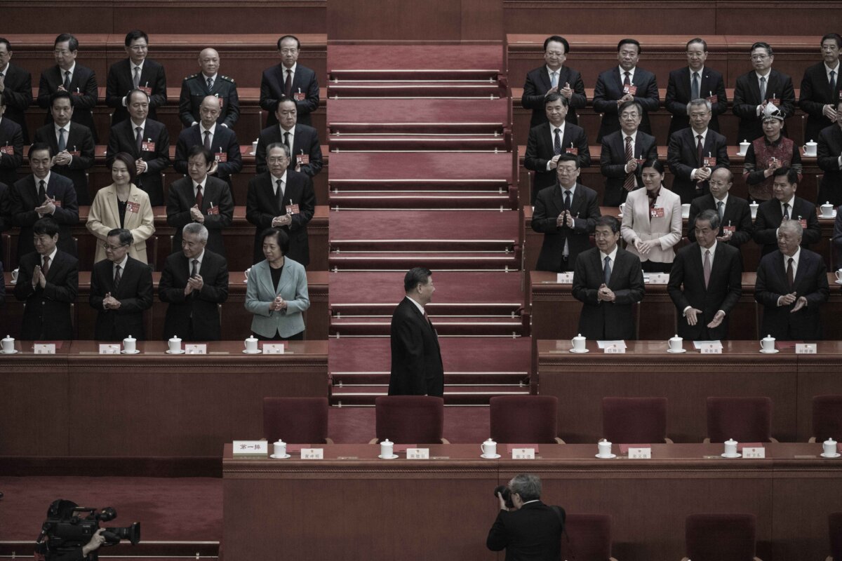 Chinese leader Xi Jinping (C) is applauded as he arrives at the closing session of the National People's Congress at the Great Hall of the People in Beijing on March 11, 2024. (Kevin Frayer/Getty Images)