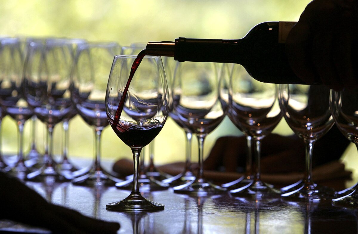 A worker at a winery pours a glass of wine for a tasting in Rutherford, Calif., in this file photo. (Justin Sullivan/Getty Images)