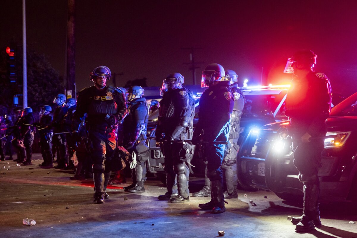 Law enforcement officers stand guard as they face off with demonstrators during a protest following federal immigration operations, in the Compton neighborhood of Los Angeles, early on June 8, 2025. (Etienne Laurent/AFP via Getty Images)