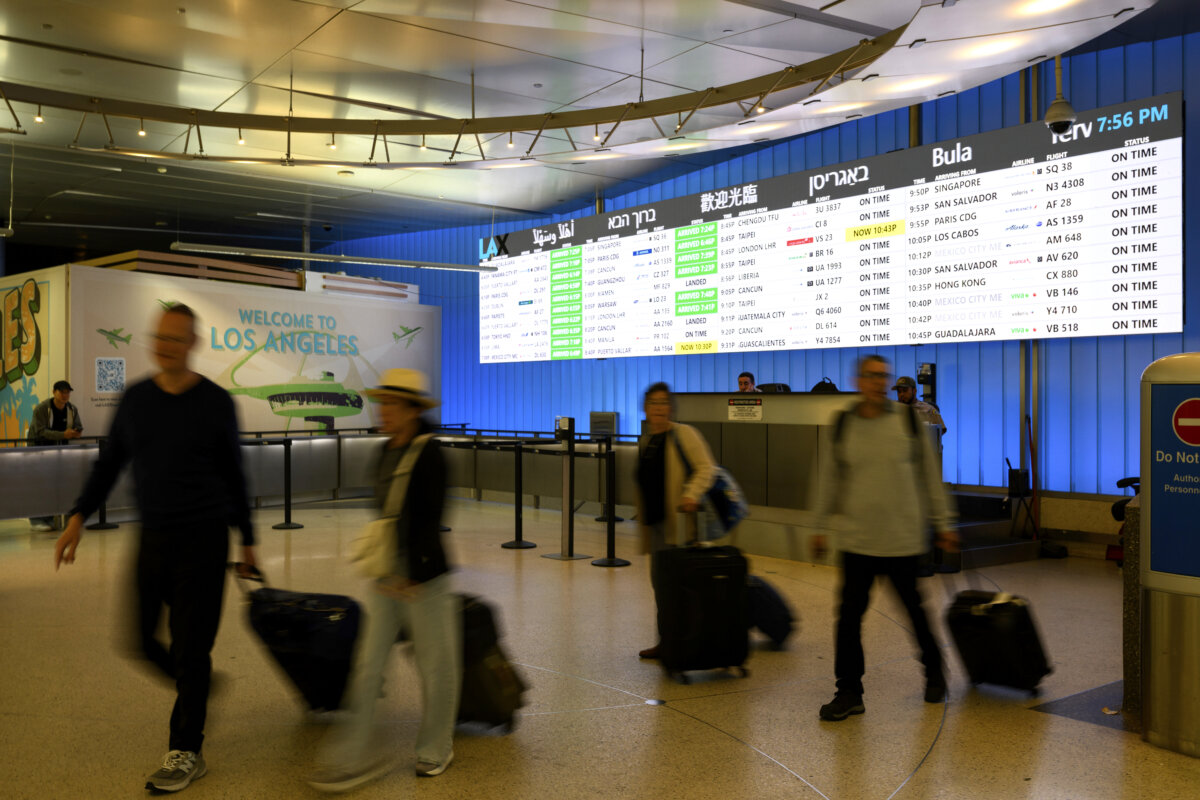 Travelers cart their luggage through the international arrivals area at the Los Angeles International Airport in Los Angeles on June 8, 2025. (William Liang/AP Photo)