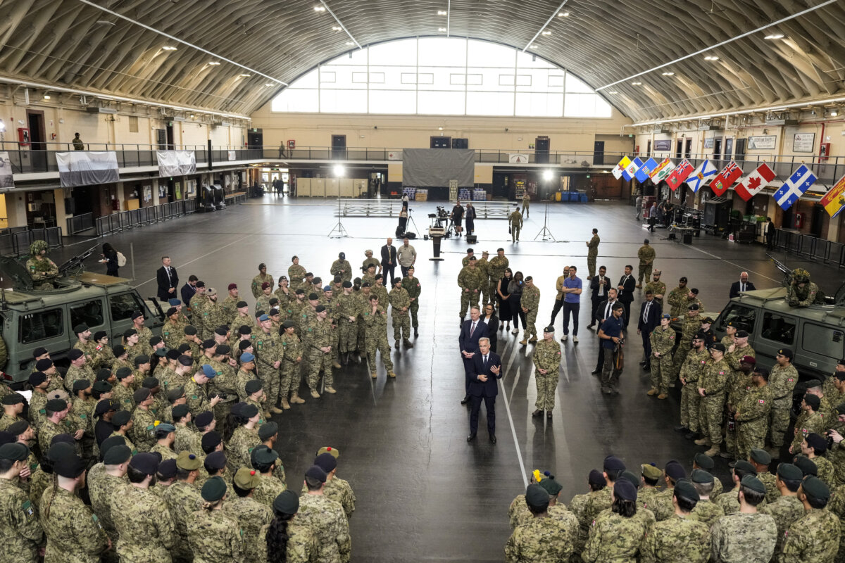 Prime Minister Mark Carney speaks to service personnel after making an announcement as he visits Fort York Armoury in Toronto on June 9, 2025. (Chris Young/The Canadian Press)