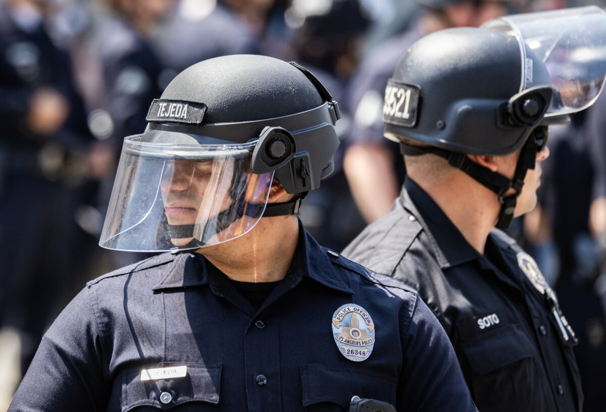 Police officers block a road leading to a federal facility in downtown Los Angeles on June 9, 2025. (John Fredricks/The Epoch Times)