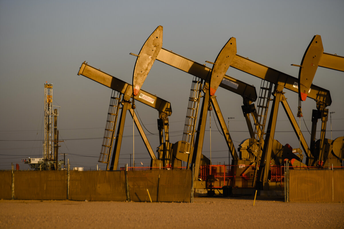 An array of pumpjacks operate near the site of a new oil and gas well being drilled in Midland, Texas, on April 8, 2022. (Eli Hartman/Odessa American via AP)