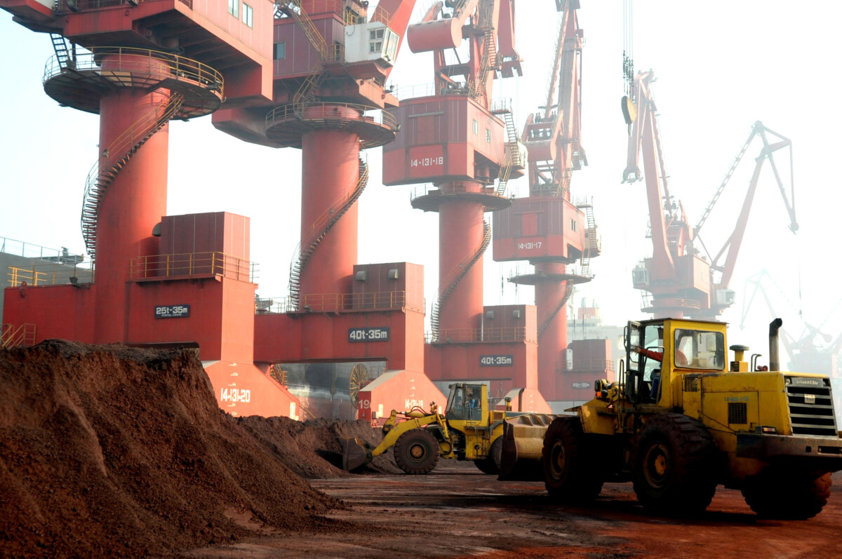 Workers transport soil containing rare earth elements for export at a port in Lianyungang, Jiangsu province, China, on Oct. 31, 2010. (Reuters)
