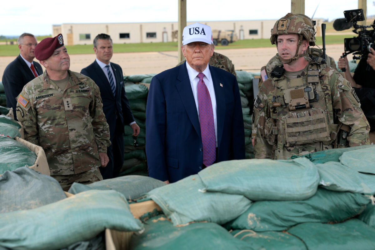 President Donald Trump is joined by 18th Airborne Corps Commander Lt. Gen. Gregory Anderson (in beret) and other military and civilian leaders, including Veterans Affairs Secretary Doug Collins and Defense Secretary Pete Hegseth, as they watch a demonstration by Special Operations soldiers at the Holland Drop Zone in Fort Bragg, N.C., on June 10, 2025. (Anna Moneymaker/Getty Images)