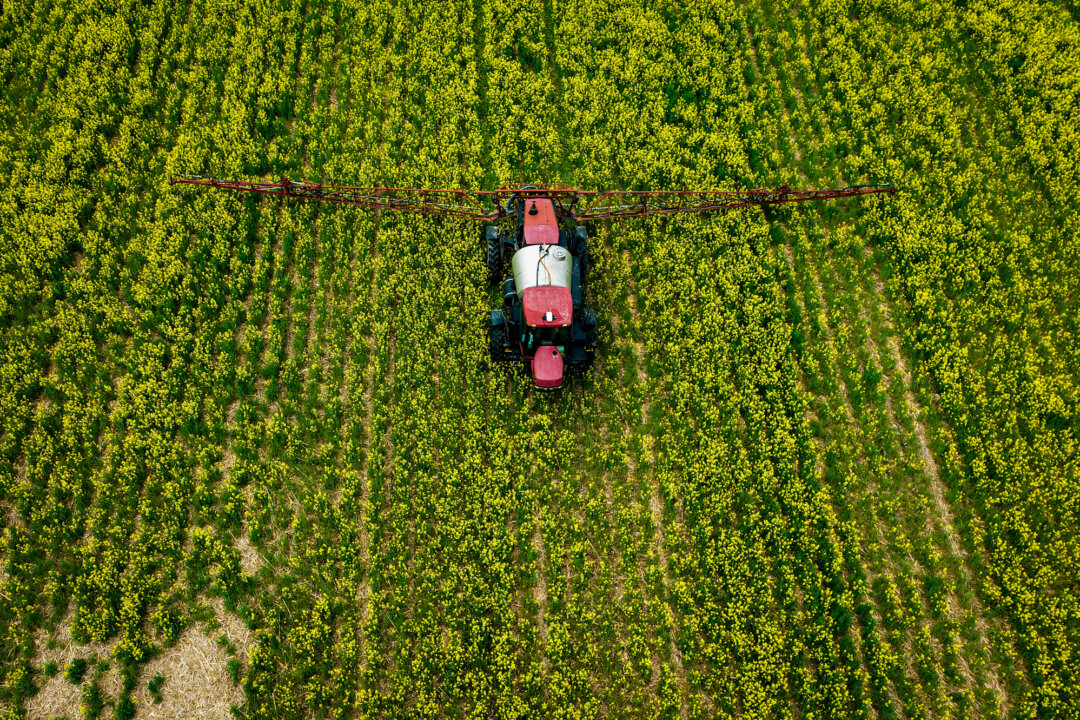 A farmer spreads pesticides on a field in Centreville, Md., on April 25, 2022. (Jim Watson/AFP via Getty Images)