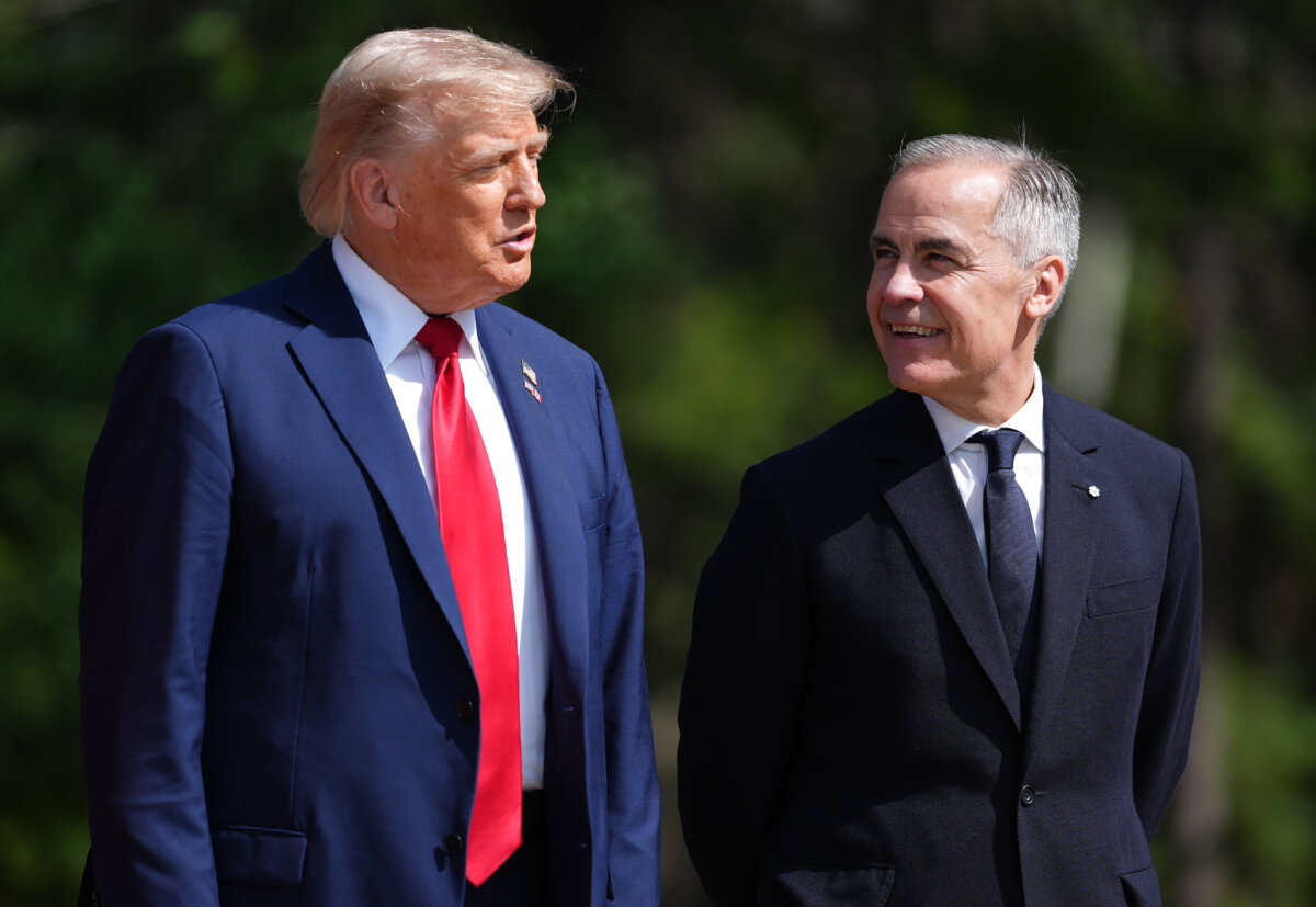 U.S. President Donald Trump (L) and Canadian Prime Minister Mark Carney talk during the official welcoming to the G7 Summit in Kananaskis, Alta., on June 16, 2025. (The Canadian Press/Darryl Dyck)