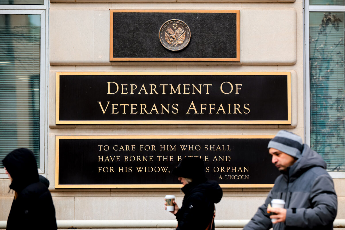 People walk past the Department of Veterans Affairs headquarters, a block from the White House, in Washington on March 6, 2025. (Chip Somodevilla/Getty Images)