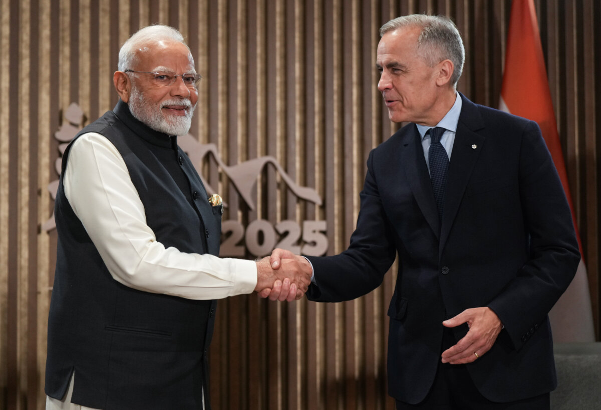 Indian Prime Minister Narendra Modi (L) and Canadian Prime Minister Mark Carney shake hands during a meeting at the G7 Summit in Kananaskis, Alta., on June 17, 2025. (The Canadian Press/Darryl Dyck)