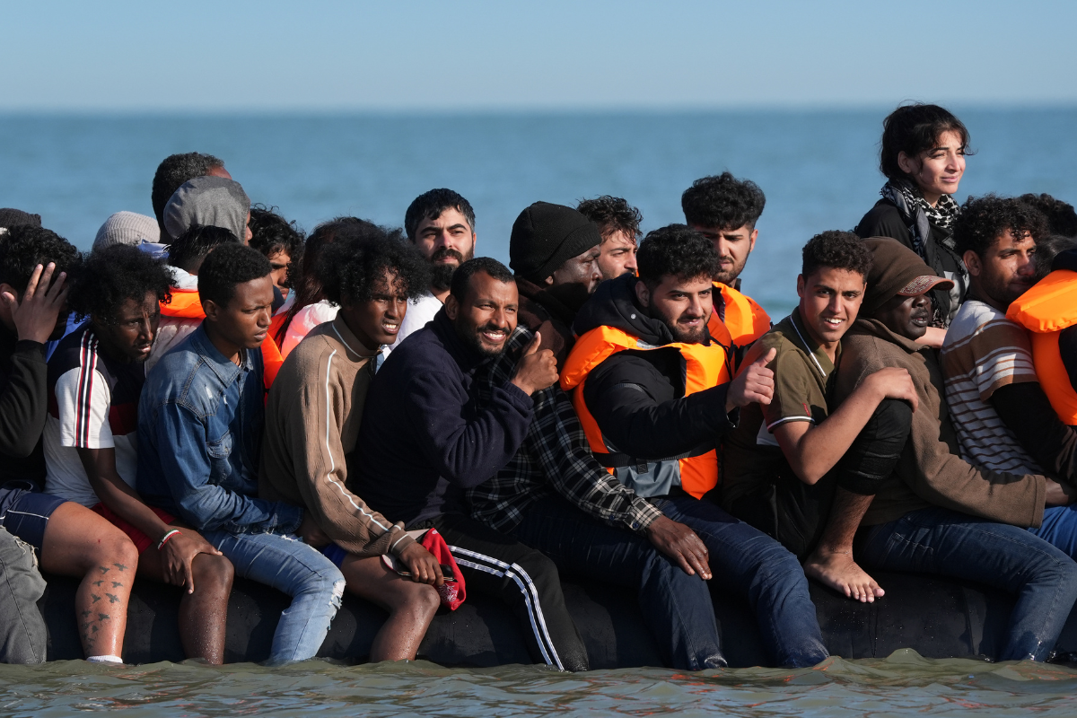 A group of migrants board a dinghy near the beach at Gravelines, France, on June 17, 2025. (Gareth Fuller/PA Wire)