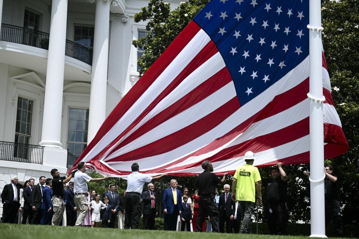 President Donald Trump looks on as a US flag is raised on a newly installed flagpole on the South Lawn of the White House in Washington on June 18, 2025. (Brendan Smialowki/AFP via Getty Images)