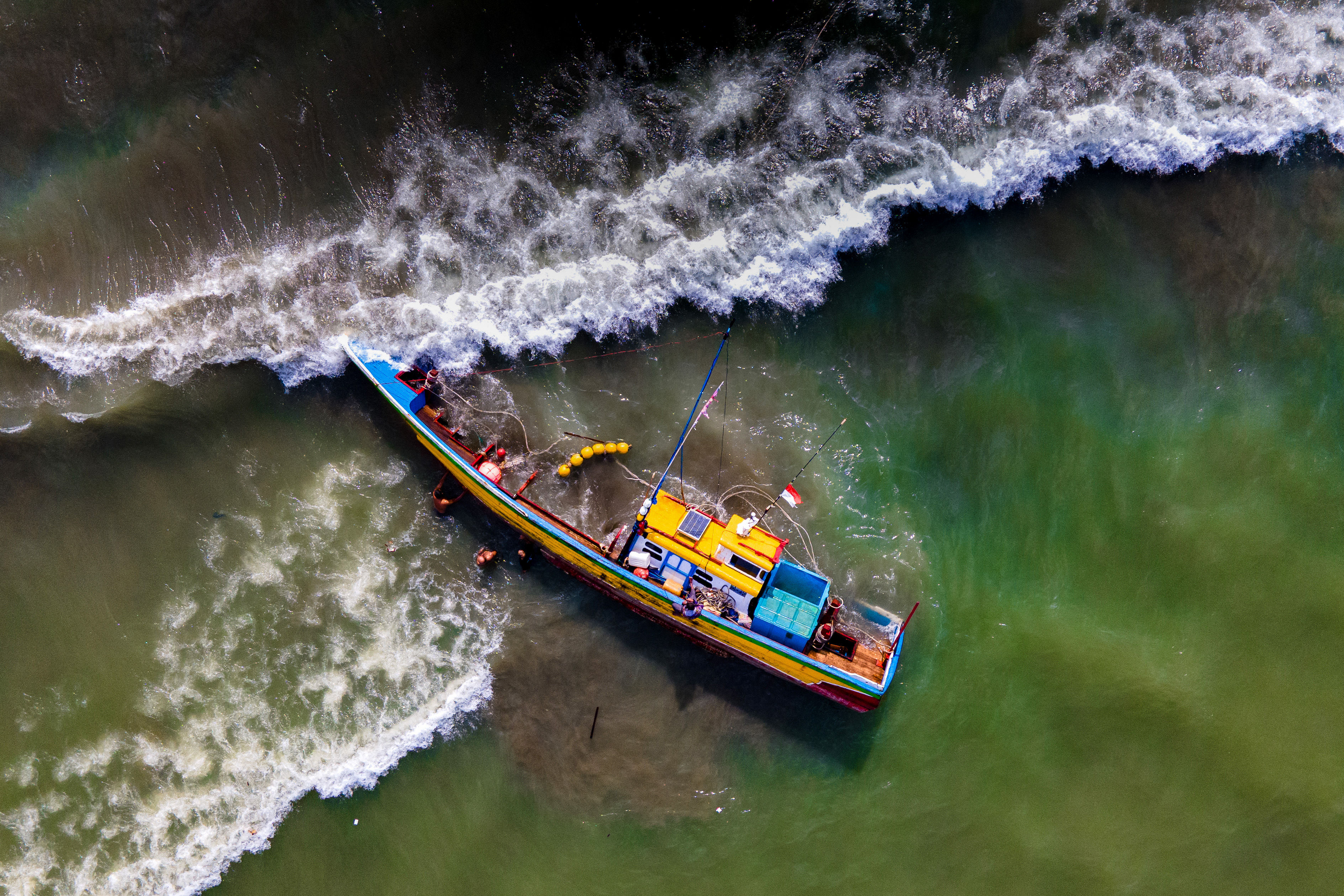 Day in Photos: Ship Capsizes in Indonesia, Forest Fires in Greece, Amazon Launches Satellites