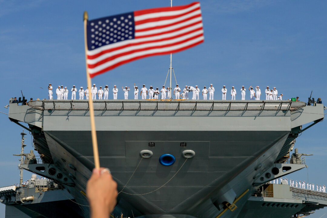 NextImg:Day in Photos: Departure of the Aircraft Carrier, NATO Summit, and Olympic Cauldron Returns