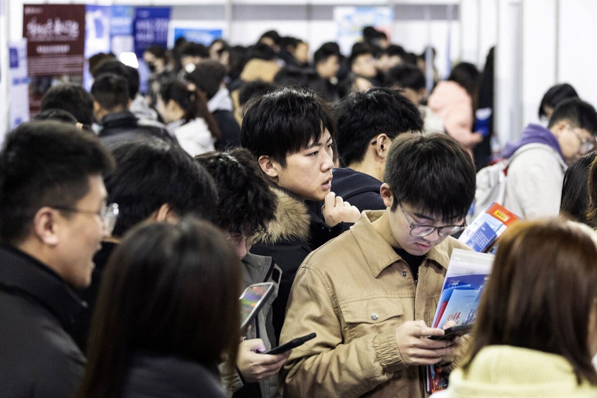 University students attend a job fair in Wuhan, in central China's Hubei Province, on March 6, 2024. With few career options and mounting disillusionment, many young Chinese are caring for elderly relatives in exchange for food, housing, or modest support, giving rise to the viral label ‘full-time grandchildren.’ (STR/AFP via Getty Images)