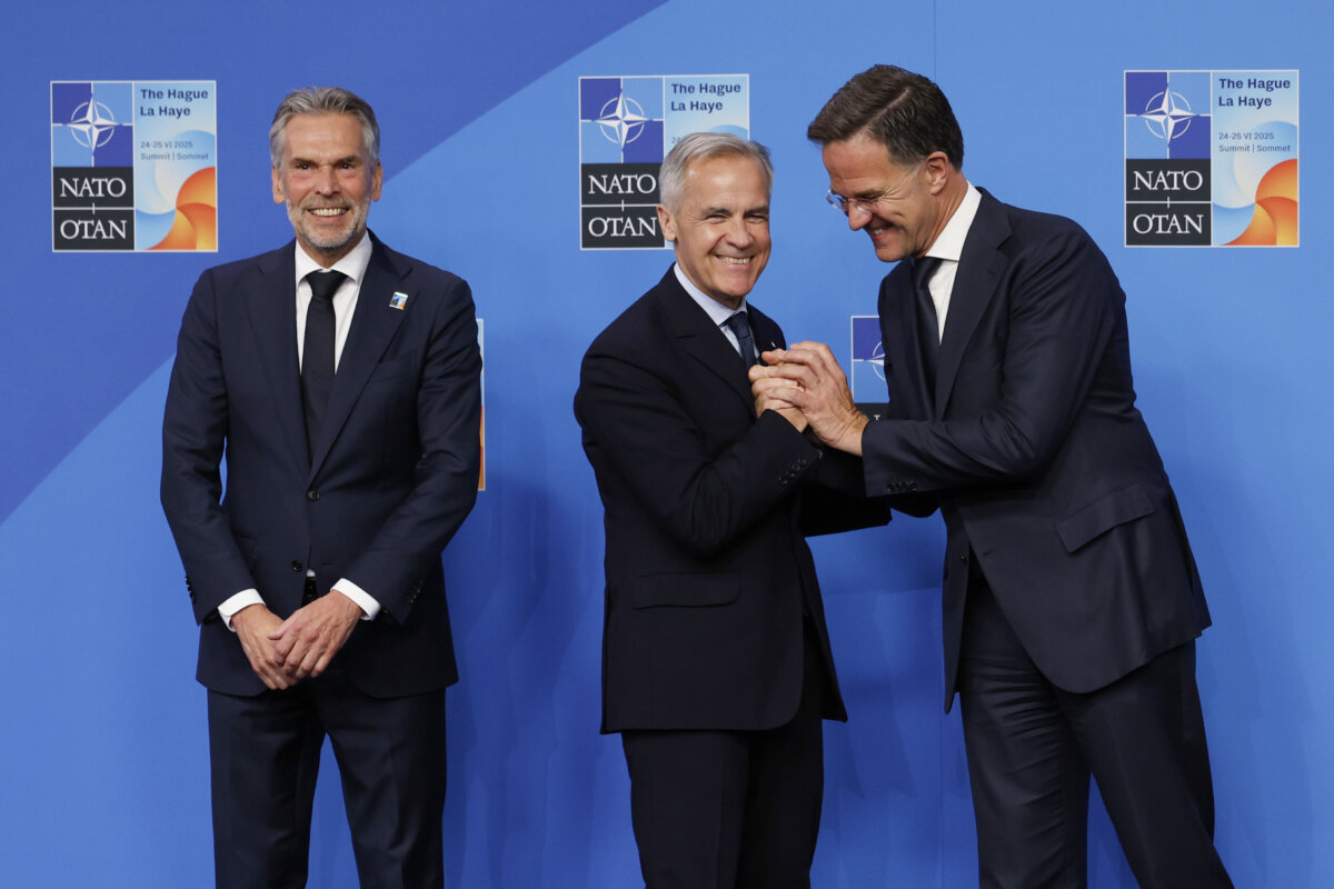 Prime Minister Mark Carney is greeted by NATO Secretary General Mark Rutte (R) and Netherland’s Prime Minister Dick Schoof during an official welcome at the NATO summit in The Hague, Netherlands, on June 25, 2025. (AP Photo/Geert Vanden Wijngaert)