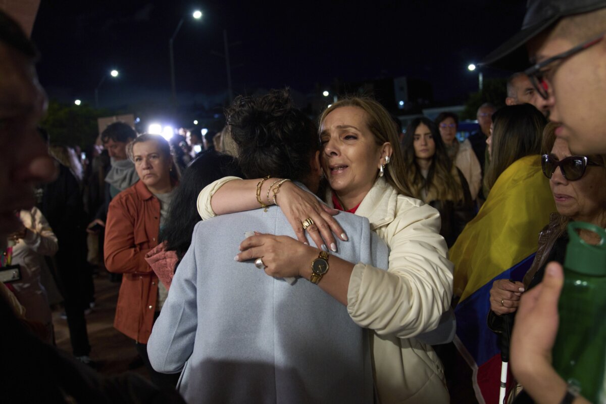 People hug each other outside the clinic where Colombian Sen. Miguel Uribe Turbay is being treated after he was shot at a political rally, in Bogota, Colombia, on June 8, 2025. (Ramon Espinosa/AP Photo)