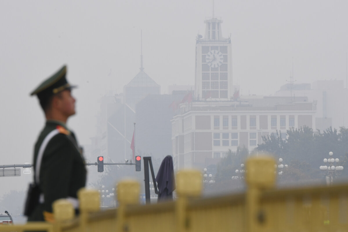 A Chinese paramilitary policeman stands guard in Tiananmen Square before the introduction of the Chinese Communist Party's Politburo Standing Committee, China's top decision-making body, on a polluted day in Beijing on Oct. 25, 2017.
(Greg Baker/AFP via Getty Images)