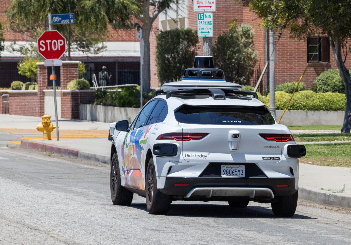 A self-driving Waymo vehicle awaits passengers in Los Angeles on July 1, 2025. (John Fredricks/The Epoch Times)