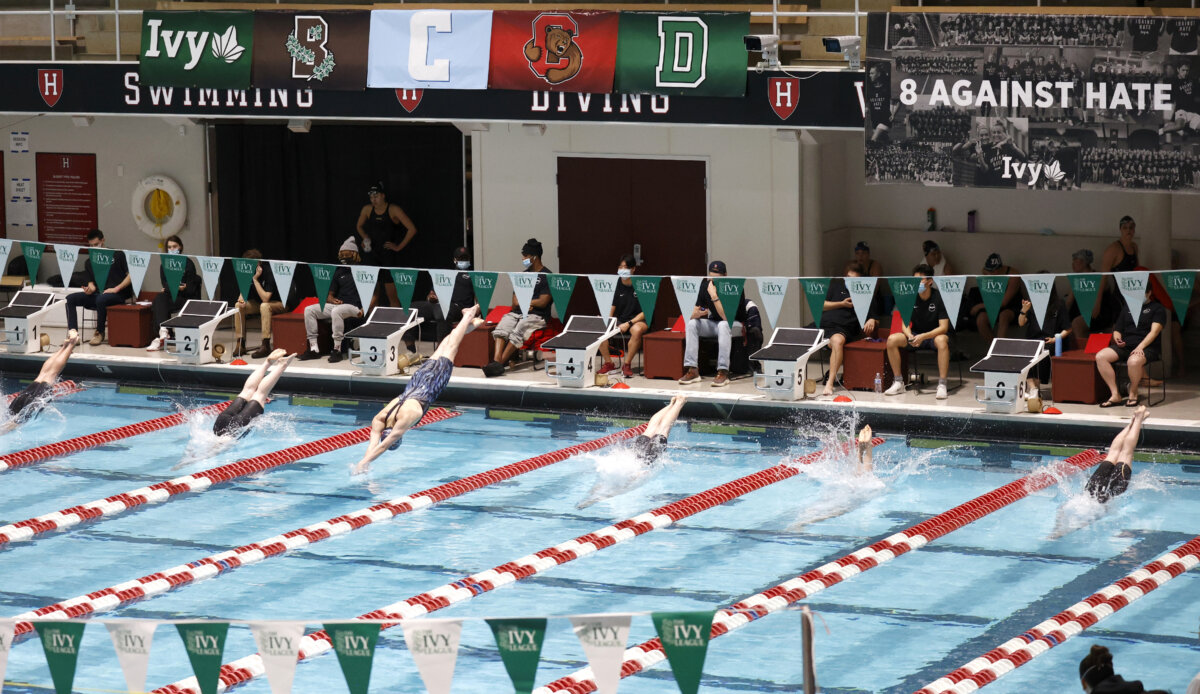 Swimmers including Penn's Lia Thomas, lane 4, dive into the water at the start of a qualifying heat of the 200 yard freestyle at the Ivy League Women's Swimming and Diving Championships at Harvard University in Cambridge, Mass., on Feb. 18, 2022. (Mary Schwalm/AP Photo)