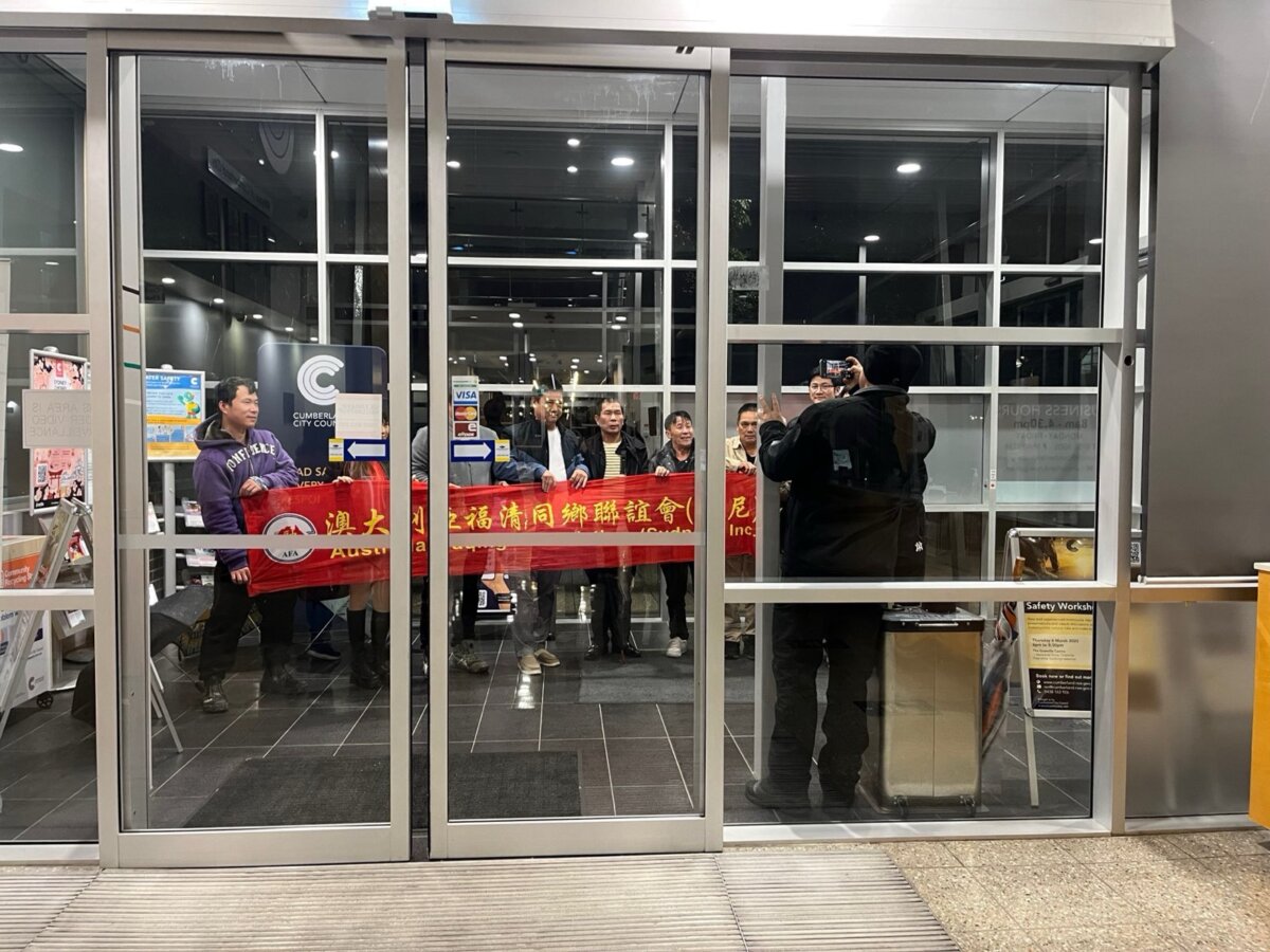 CCP supporters and members of the Fuqing Association posing for a photo in the Cumberland City Council building in Sydney, Australia on July 30, 2025. (Cindy Li/The Epoch Times)