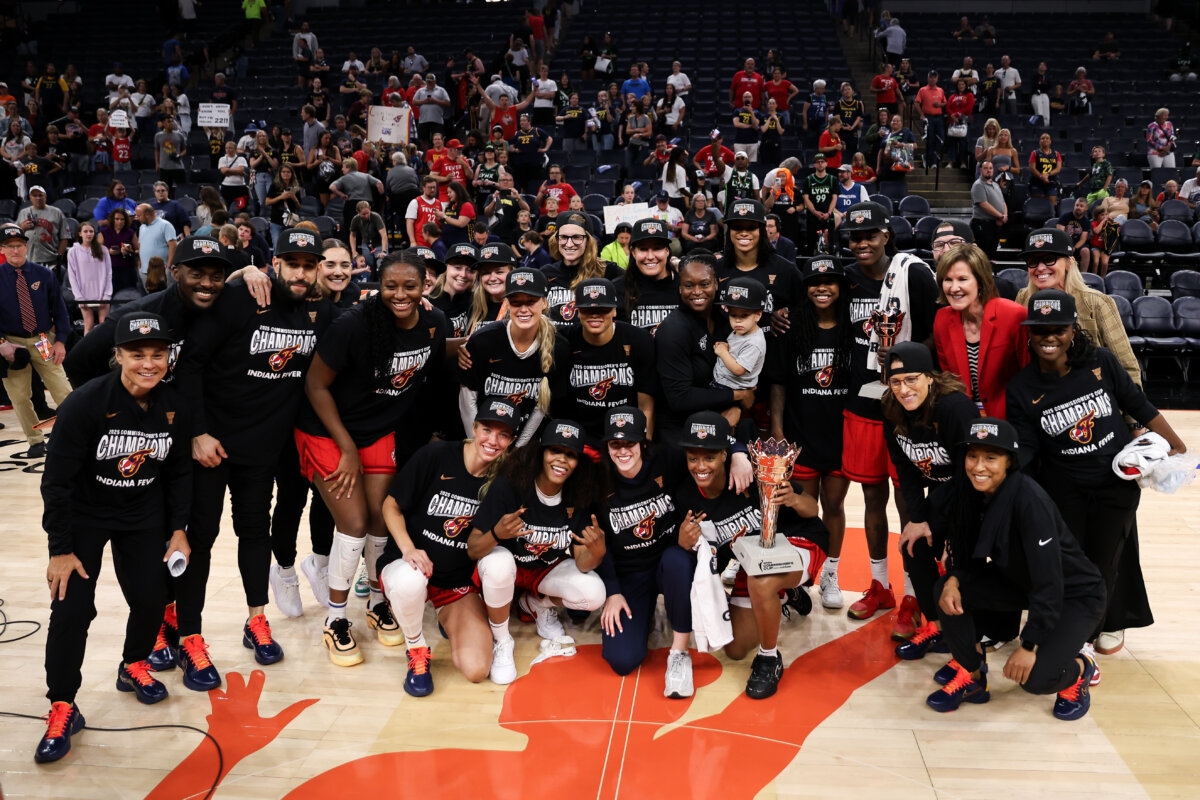 The Indiana Fever players and coaches pose for a photo with the 2025 Commissioners Cup trophy after the game against the Minnesota Lynx at Target Center in Minneapolis, Minn., on July 1, 2025. (Matt Krohn/Getty Images)