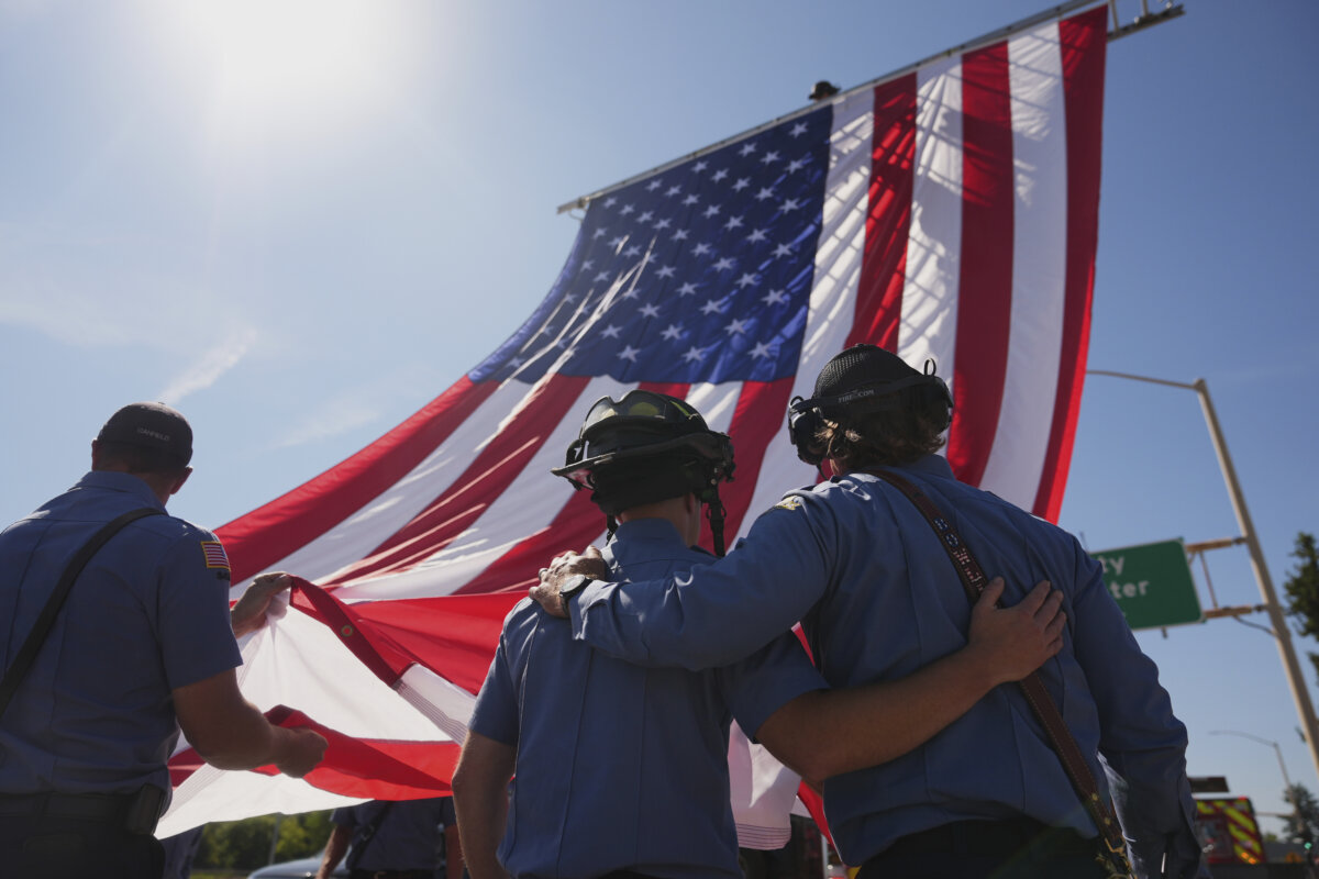 The Coeur d'Alene Fire Department hangs an American flag to honor the firefighters who were killed on June 29, 2025, in Coeur d'Alene, Idaho, on July 1, 2025. (Lindsey Wasson/AP Photo)