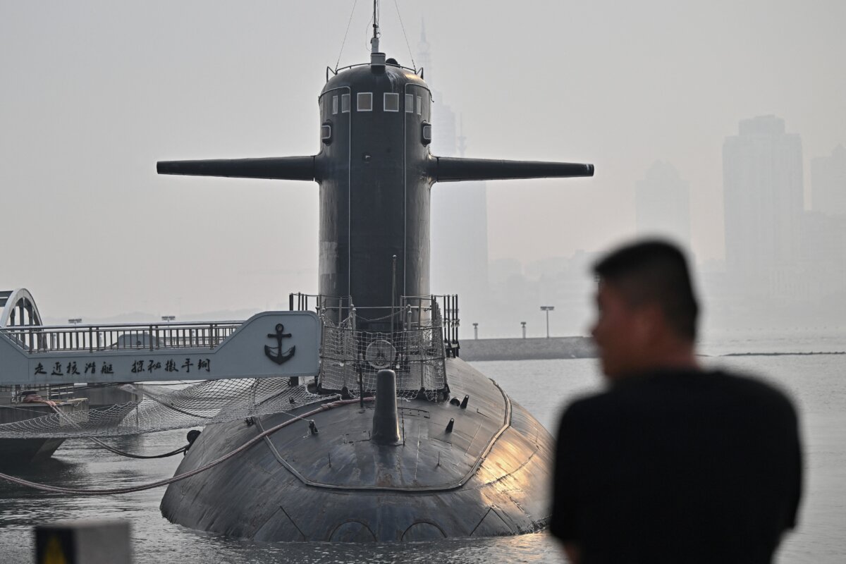 A man looks at a submarine during a media tour by the PLA Naval Museum, organized by the Chinese People's Liberation Army Navy ahead of the Defense Ministers' Meeting of the Shanghai Cooperation Organization (SCO) Member States in Qingdao, in eastern Shandong Province, China, on June 25, 2025. (Pedro Pardo/AFP via Getty Images)