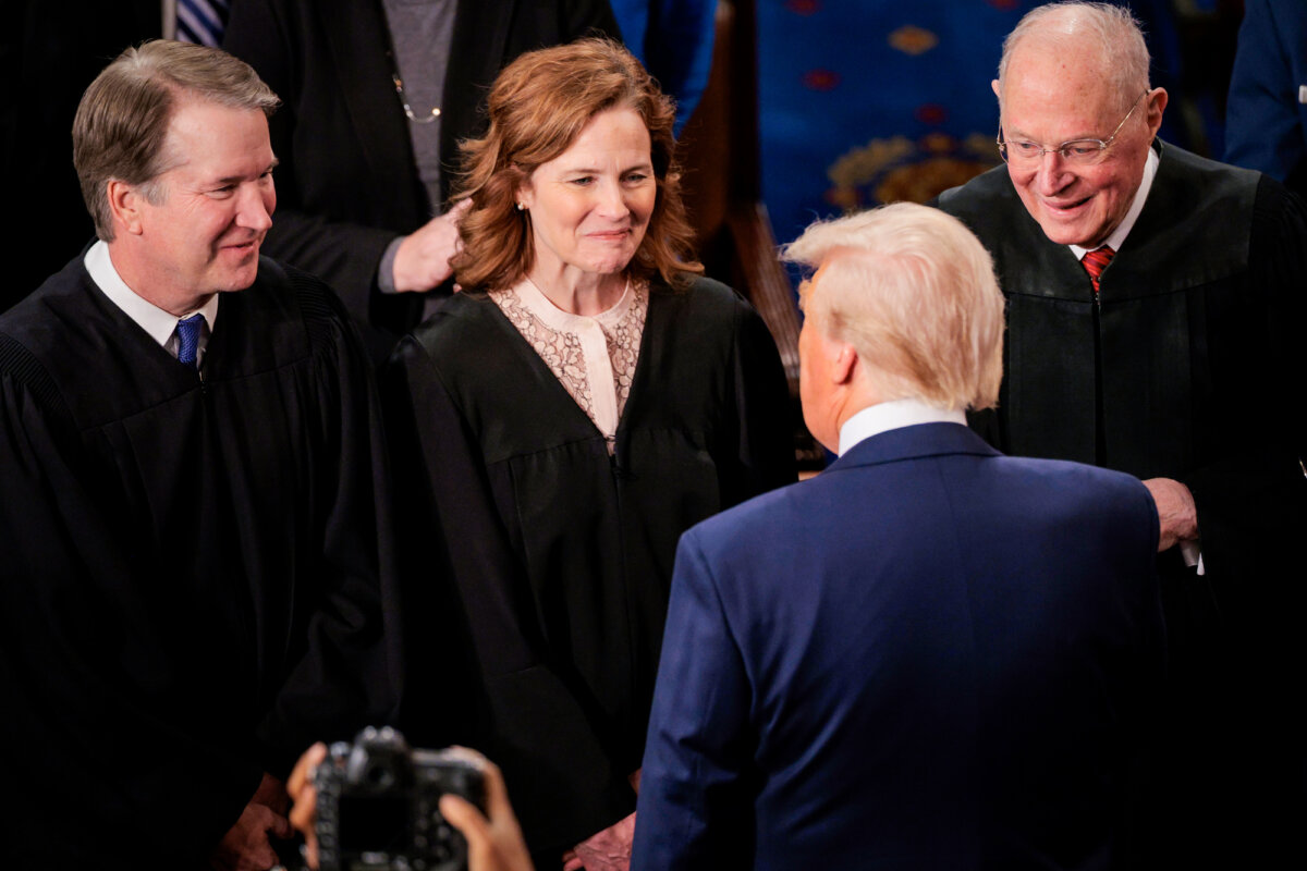 (L–R) Supreme Court Associate Justices Brett Kavanaugh, Amy Coney Barrett, and former Associate Justice Anthony Kennedy talk with President Donald Trump as he arrives to address a joint session of Congress at the Capitol on March 4, 2025. (Chip Somodevilla/Getty Images)