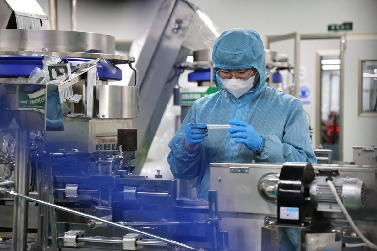 A worker produces medical supplies that will be exported at a factory in Binzhou, in China's eastern Shandong province on June 15, 2023. (STR/AFP via Getty Images)
