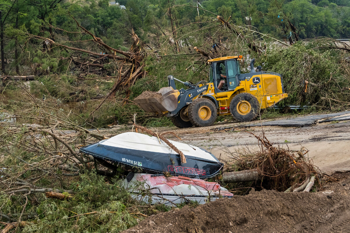 Crews work to clear debris from the Cade Loop bridge along the Guadalupe River in Ingram, Texas, on July 5, 2025. (Rodolfo Gonzalez/AP Photo)
