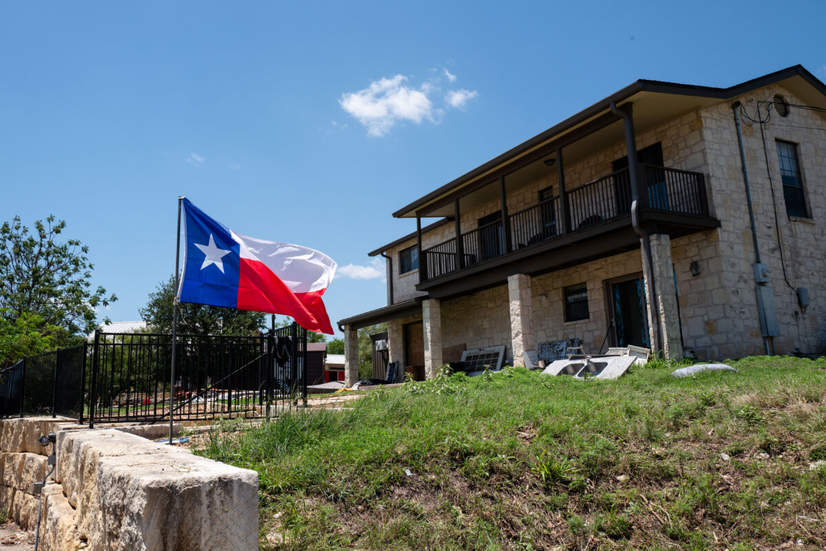 Texas flag at a house next to the Guadalupe River in the aftermath of flash floods in Kerrville, Texas, on July 8, 2025. (Madalina Kilroy/The Epoch Times)