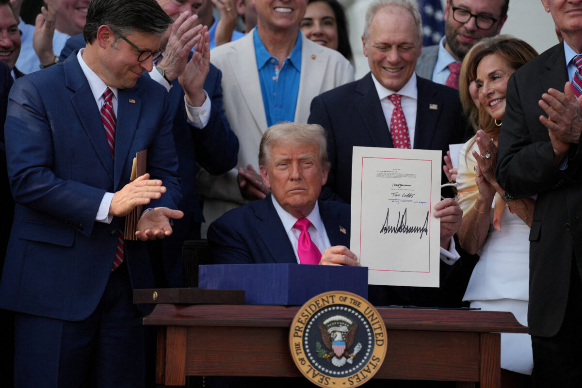 President Donald Trump presents a sweeping spending and tax legislation, known as the "One Big Beautiful Bill Act," after he signed it, at the White House on July 4, 2025. (Leah Millis/Reuters)