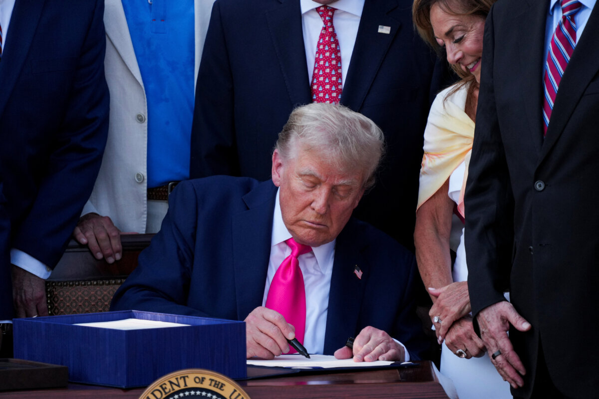 President Donald Trump signs the spending and tax legislation known as the "One Big Beautiful Bill Act," at the White House on July 4, 2025. (Ken Cedeno/Reuters)