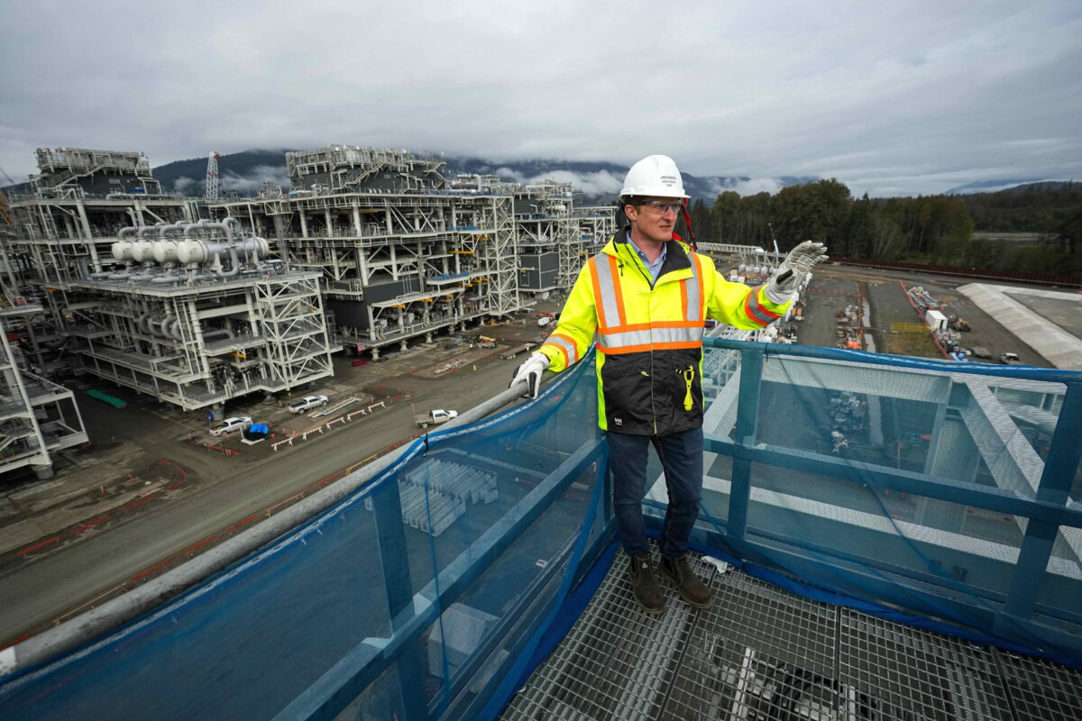 Then-LNG Canada CEO Jason Klein stands atop a receiving platform overlooking LNG processing units called trains that are used to convert natural gas into liquefied natural gas, at the LNG Canada export terminal under construction in Kitimat, B.C., on Sept. 28, 2022. (The Canadian Press/Darryl Dyck)