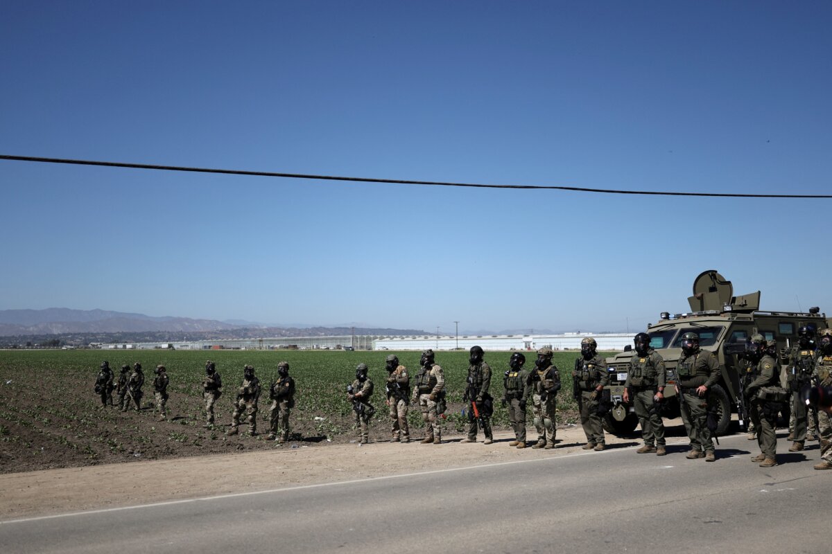 Federal agents block a road leading to an agricultural facility where U.S. federal agents and immigration officers conducted an operation, in Camarillo, Calif., on July 10, 2025. (Daniel Cole/Reuters)