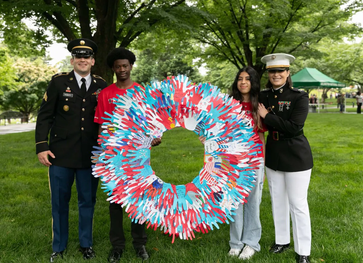 Marine officer Amanda Carnes (rightmost) said it was one of her greatest honors to help carry a wreath created by children of fallen veterans, during a Memorial Day event in 2023. (Courtesy of TAPS)