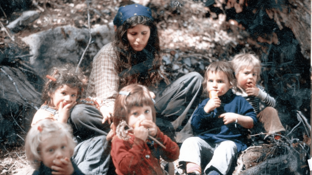 Young woman with dark blue bandana and children in Commune