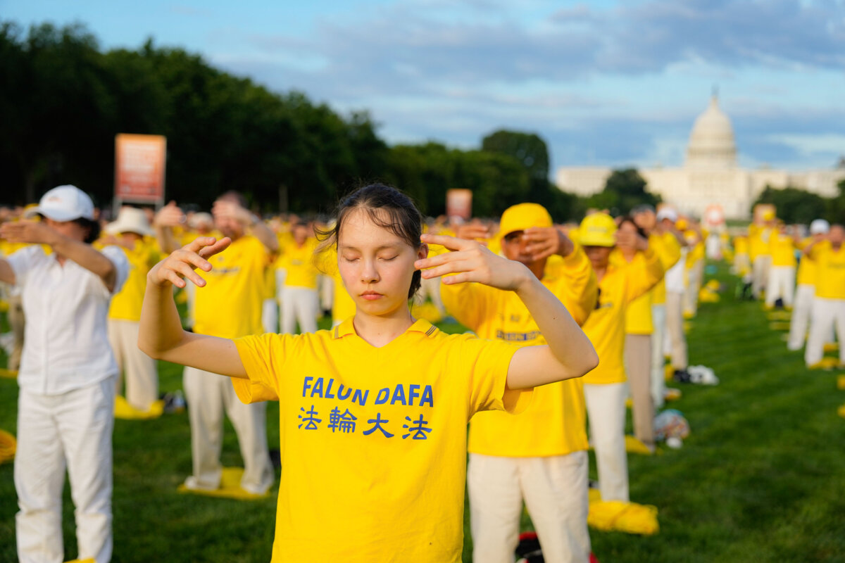 Falun Gong practitioners during an event to commemorate those killed by the Chinese communist regime, on the National Mall in Washington on July 11, 2024. (Larry Dye/The Epoch Times)