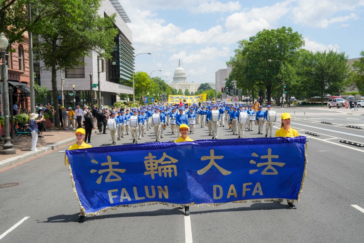 Falun Dafa practitioners take part in a march calling for the end of the Chinese Communist Party’s 26 years of persecution of Falun Gong in China, in Washington on July 17, 2025. (Samira Bouaou/The Epoch Times)
