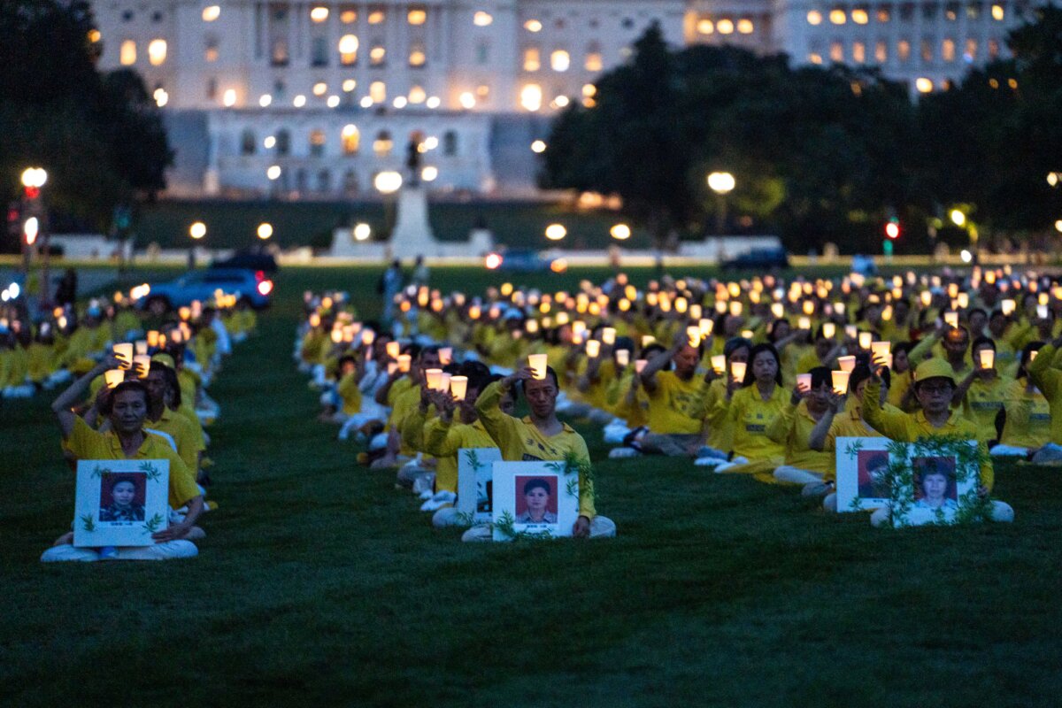 Falun Dafa practitioners take part in a candlelight vigil commemorating Falun Gong practitioners who were persecuted to death by the Chinese Communist Party in China, in Washington on July 17, 2025. (Madalina Kilroy/The Epoch Times)