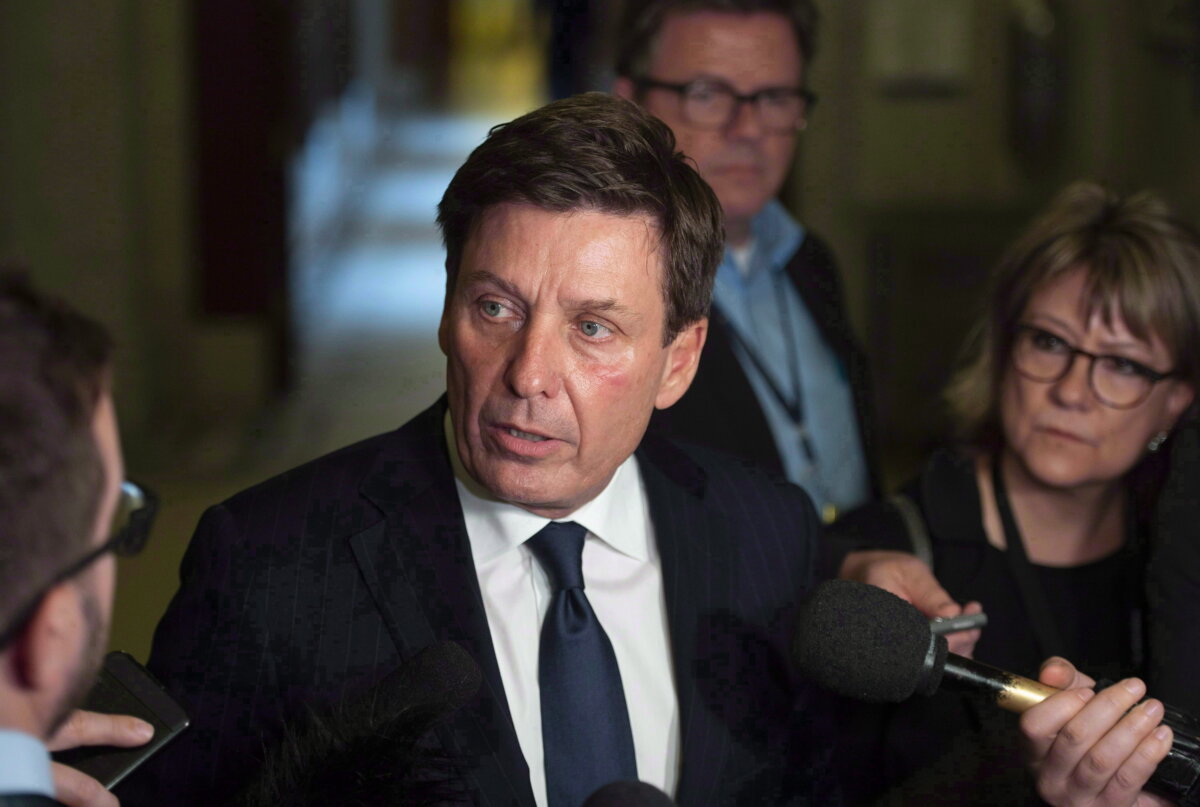 Then-Quebec Energy and Natural Resources Minister Pierre Moreau responds to reporters questions at the National Assembly, in Quebec City on Oct. 11, 2018. (The Canadian Press/Jacques Boissinot)