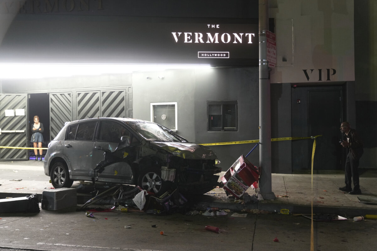 A vehicle sits on the sidewalk after ramming into a crowd of people waiting to enter a nightclub along a busy boulevard and injuring several people, in Los Angeles early Saturday, July 19, 2025. (Damian Dovarganes/AP Photo)