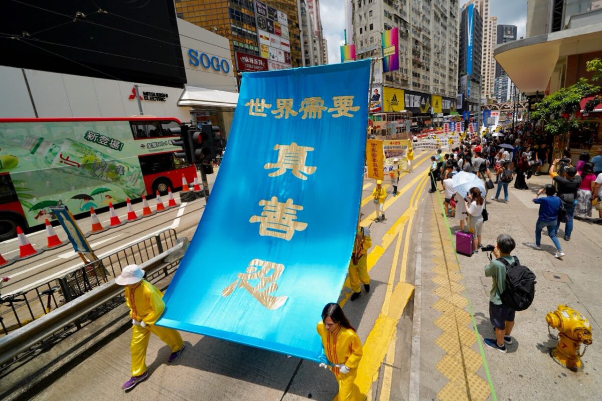 Falun Gong practitioners held a march through Causeway Bay, in Hong Kong, on July 21, 2019, commemorating the 20th anniversary of the anti-persecution movement. (Li Yi/The Epoch Times)