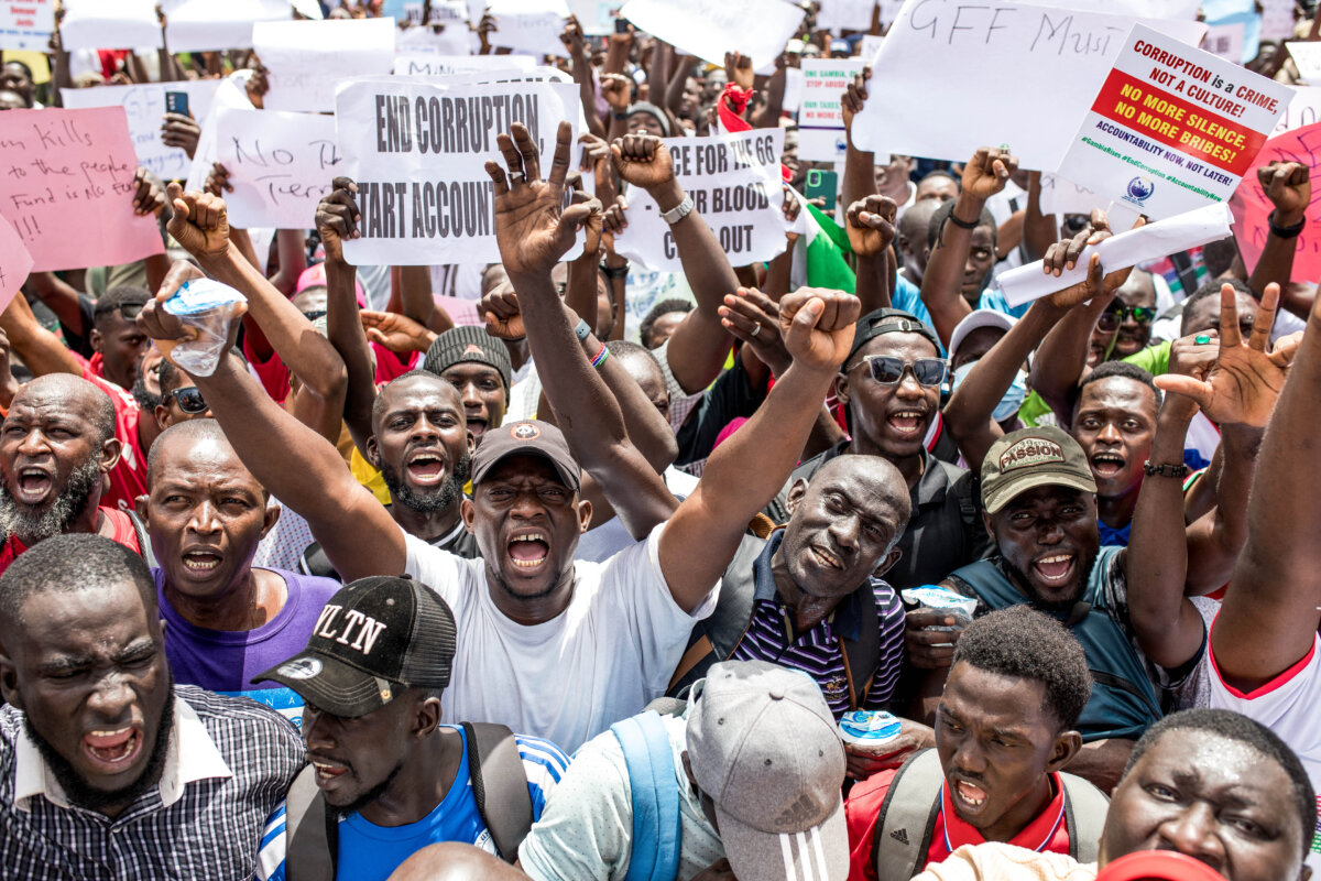Protesters hold placards and chant slogans during a demonstration demanding transparency and accountability from government leaders, organized by Gambians Against Looted Assets (GALA), in Banjul on July 23, 2025. Thousands of Gambians protested in Banjul, on July 23, 2025, alleging government corruption and demanding justice over a series of recent scandals. (Muhamadou Bittaye/AFP via Getty Images)