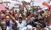 Day in Photos: Protests in Gambia, Detention of Illegal Immigrant, and Peace Talks Between Ukraine and Russia