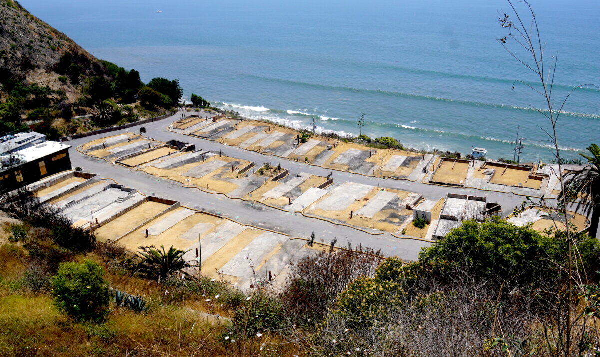 Empty foundations of former residences that burned in the Los Angeles fires along the coastline in Pacific Palisades, Calif., on July 5, 2025. (Allan Stein/The Epoch Times)