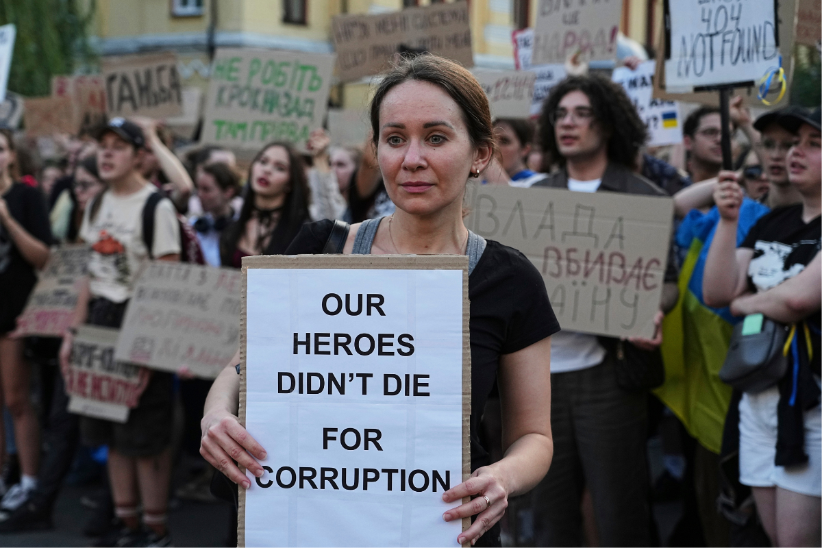 A woman holds a banner during a protest against a law targeting anti-corruption institutions in central Kyiv, Ukraine, Wednesday, on July 23, 2025. (Efrem Lukatsky/AP Photo)