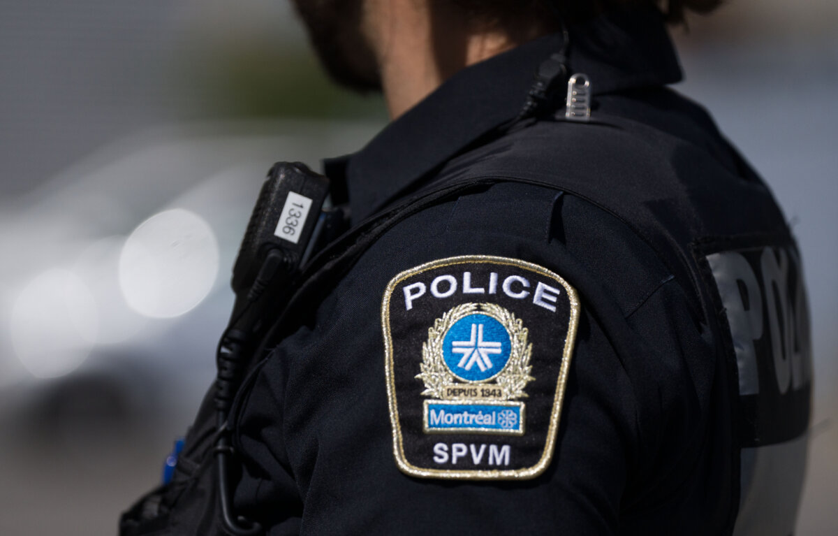 An SPVM police shoulder patch is seen on an officer in Montreal, on Aug. 29, 2024. (The Canadian Press/Christinne Muschi)