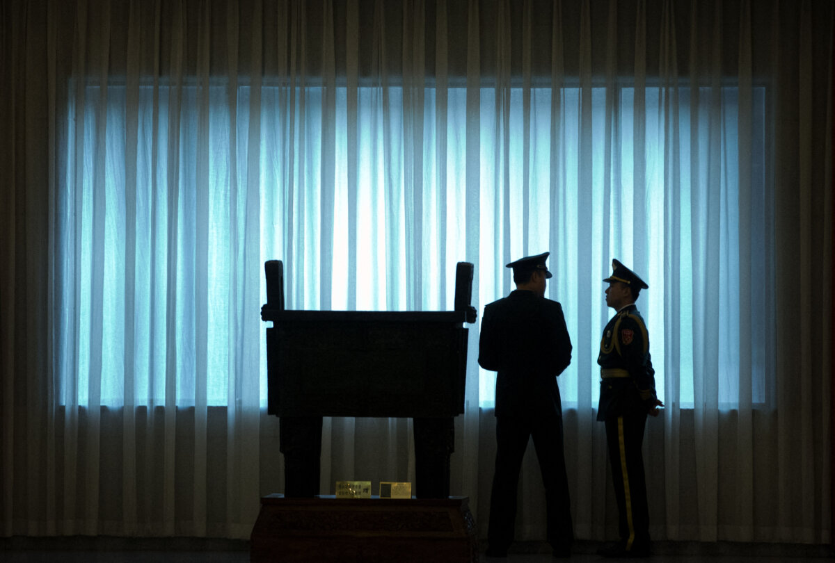 China's People's Liberation Army (PLA) officers stand in front of a window before a welcome ceremony for U.S. Army Chief of Staff Gen. Mark Milley at the Bayi Building in Beijing on Aug. 16, 2016. (Mark Schiefelbein/POOL/AFP via Getty Images)